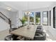 Bright dining room features a large table with seating, stylish light fixture, and lots of natural light from large windows at 114 W Plymouth St, Tampa, FL 33603