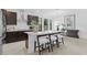 Modern kitchen featuring a large island with seating, stainless steel appliances, and stylish dark wood cabinets at 114 W Plymouth St, Tampa, FL 33603