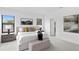 Bright main bedroom with neutral color palette, bench seating, stylish lamps, and an ensuite bathroom at 114 W Plymouth St, Tampa, FL 33603