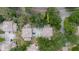 Aerial view of townhomes with mature trees and parking areas at 11802 Foxrun Ln, Temple Terrace, FL 33617