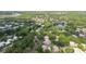 Scenic aerial view of a neighborhood with a tranquil lake surrounded by lush greenery at 11802 Foxrun Ln, Temple Terrace, FL 33617