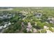Wide aerial view showing the property's proximity to a pond and nearby roadways at 11802 Foxrun Ln, Temple Terrace, FL 33617