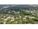 Overhead view of a community with mature trees and a pond in a desirable neighborhood at 11802 Foxrun Ln, Temple Terrace, FL 33617