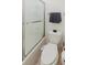 Clean bathroom featuring a toilet, towel rack, and a shower with glass door at 11802 Foxrun Ln, Temple Terrace, FL 33617