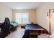 Bright bedroom with hardwood floors, a window, and comfortable furniture with modern lighting at 11802 Foxrun Ln, Temple Terrace, FL 33617