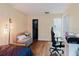 Bedroom featuring hardwood floors, a cozy sitting area, and a view of the closet and bathroom at 11802 Foxrun Ln, Temple Terrace, FL 33617