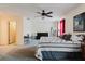 Bright bedroom featuring soft carpet, a ceiling fan, and a stylish bed with comfortable furniture at 11802 Foxrun Ln, Temple Terrace, FL 33617