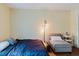Bright bedroom featuring hardwood floors, a cozy sitting area, and a queen-sized bed at 11802 Foxrun Ln, Temple Terrace, FL 33617