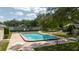 Enjoy a sunny day at the community pool, complete with lounge chairs, and a fenced in area at 11802 Foxrun Ln, Temple Terrace, FL 33617