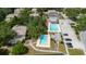 Aerial view of the community featuring two pools, a clubhouse, and ample parking for residents and guests at 11802 Foxrun Ln, Temple Terrace, FL 33617