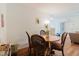 Cozy dining area with a round table, four chairs, and view into the living room creating a seamless and inviting space at 11802 Foxrun Ln, Temple Terrace, FL 33617