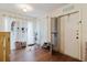 Bright entryway with hardwood floors, white walls, and a light fixture creates a cozy and inviting atmosphere at 11802 Foxrun Ln, Temple Terrace, FL 33617