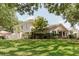 Charming two-story home with well-maintained landscaping and lush green lawn at 11802 Foxrun Ln, Temple Terrace, FL 33617