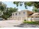 Exterior featuring garages, a private entrance, and mature trees providing shade at 11802 Foxrun Ln, Temple Terrace, FL 33617
