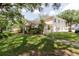 Inviting home exterior with a well-manicured lawn and mature shade trees at 11802 Foxrun Ln, Temple Terrace, FL 33617