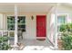 Welcoming front porch with visible address, seating, and well maintained landscape at 11802 Foxrun Ln, Temple Terrace, FL 33617