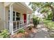 Charming front porch with a bench and lush landscaping near the sidewalk at 11802 Foxrun Ln, Temple Terrace, FL 33617