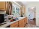Kitchen featuring stainless sink and ample counter space with a view to the living area at 11802 Foxrun Ln, Temple Terrace, FL 33617