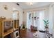 Bright living room with hardwood floors, plants and white curtains allowing natural light at 11802 Foxrun Ln, Temple Terrace, FL 33617