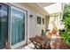 Cozy outdoor patio with dining table, string lights and a sliding glass door at 11802 Foxrun Ln, Temple Terrace, FL 33617
