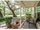 Cozy porch with a bench, offering a relaxing view of the tree-lined street at 11802 Foxrun Ln, Temple Terrace, FL 33617