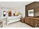 Bedroom featuring wood floors, large windows, dresser, and a neutral color scheme with closet access at 1235 S Highland Ave # 2-207, Clearwater, FL 33756