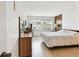 Bedroom featuring wood floors, large windows, dresser, and a neutral color scheme at 1235 S Highland Ave # 2-207, Clearwater, FL 33756