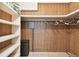 Walk-in closet with built-in shelving on the left and wood paneled walls at 1235 S Highland Ave # 2-207, Clearwater, FL 33756
