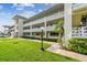 Well maintained multi-story building with lush green lawn and decorative white concrete railing at 1235 S Highland Ave # 2-207, Clearwater, FL 33756