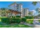 Exterior view of the building with landscaping and covered sitting area in a well manicured space at 1235 S Highland Ave # 2-207, Clearwater, FL 33756