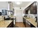 Functional kitchen featuring granite countertops and stainless steel appliances at 1235 S Highland Ave # 2-207, Clearwater, FL 33756