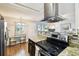 Open-concept kitchen with stainless steel appliances and a modern design at 1235 S Highland Ave # 2-207, Clearwater, FL 33756