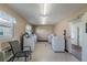 Community laundry room with multiple washing machines, a gray chair, and neutral paint at 1235 S Highland Ave # 2-207, Clearwater, FL 33756