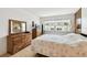 Inviting main bedroom with wood-look floors and large window at 1235 S Highland Ave # 2-207, Clearwater, FL 33756