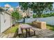 Outdoor dining area features a built-in grill, picnic table, and view of the surrounding complex at 1235 S Highland Ave # 2-207, Clearwater, FL 33756