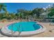 Inviting community pool surrounded by a well-maintained deck, lush landscaping, and tranquil seating areas at 1235 S Highland Ave # 2-207, Clearwater, FL 33756