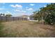 The fenced backyard features a mature tree and grass at 12419 Dawn Vista Dr, Riverview, FL 33578