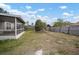 The fenced backyard features a mature tree and screened-in porch at 12419 Dawn Vista Dr, Riverview, FL 33578