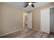 This bedroom has a connecting bathroom, closet, and wood-look floors at 12419 Dawn Vista Dr, Riverview, FL 33578
