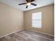 Bedroom with wood-look floors, natural light, and a ceiling fan at 12419 Dawn Vista Dr, Riverview, FL 33578