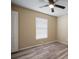 This bedroom features a ceiling fan, window with blinds, and wood-look floors at 12419 Dawn Vista Dr, Riverview, FL 33578