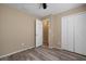 This bedroom features a ceiling fan, closet, and wood-look floors at 12419 Dawn Vista Dr, Riverview, FL 33578
