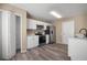 Modern kitchen with white cabinets, stainless steel appliances, and wood-look flooring at 12419 Dawn Vista Dr, Riverview, FL 33578