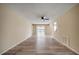 Open living room area features wood-look floors, ceiling fan, and sliding glass door access to backyard patio at 12419 Dawn Vista Dr, Riverview, FL 33578