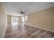 Bright and spacious living room with wood-look floors, ceiling fan, and sliding glass doors to the backyard at 12419 Dawn Vista Dr, Riverview, FL 33578