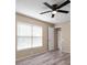 Comfortable bedroom features a ceiling fan, neutral paint, and large window for plenty of natural light at 12419 Dawn Vista Dr, Riverview, FL 33578
