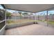 Tiled screened-in porch overlooking the spacious backyard with a fence at 12419 Dawn Vista Dr, Riverview, FL 33578