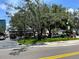 Dakota Avenue street view showcasing commercial area, trees, landscaped green space on a sunny day at 12419 Dawn Vista Dr, Riverview, FL 33578