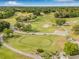 Aerial view of the golf course in the community showcasing the lush green landscape and manicured fairways at 12601 Stone House Loop, Hudson, FL 34667