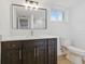 Bathroom featuring a modern vanity, large mirror, and updated fixtures at 12601 Stone House Loop, Hudson, FL 34667